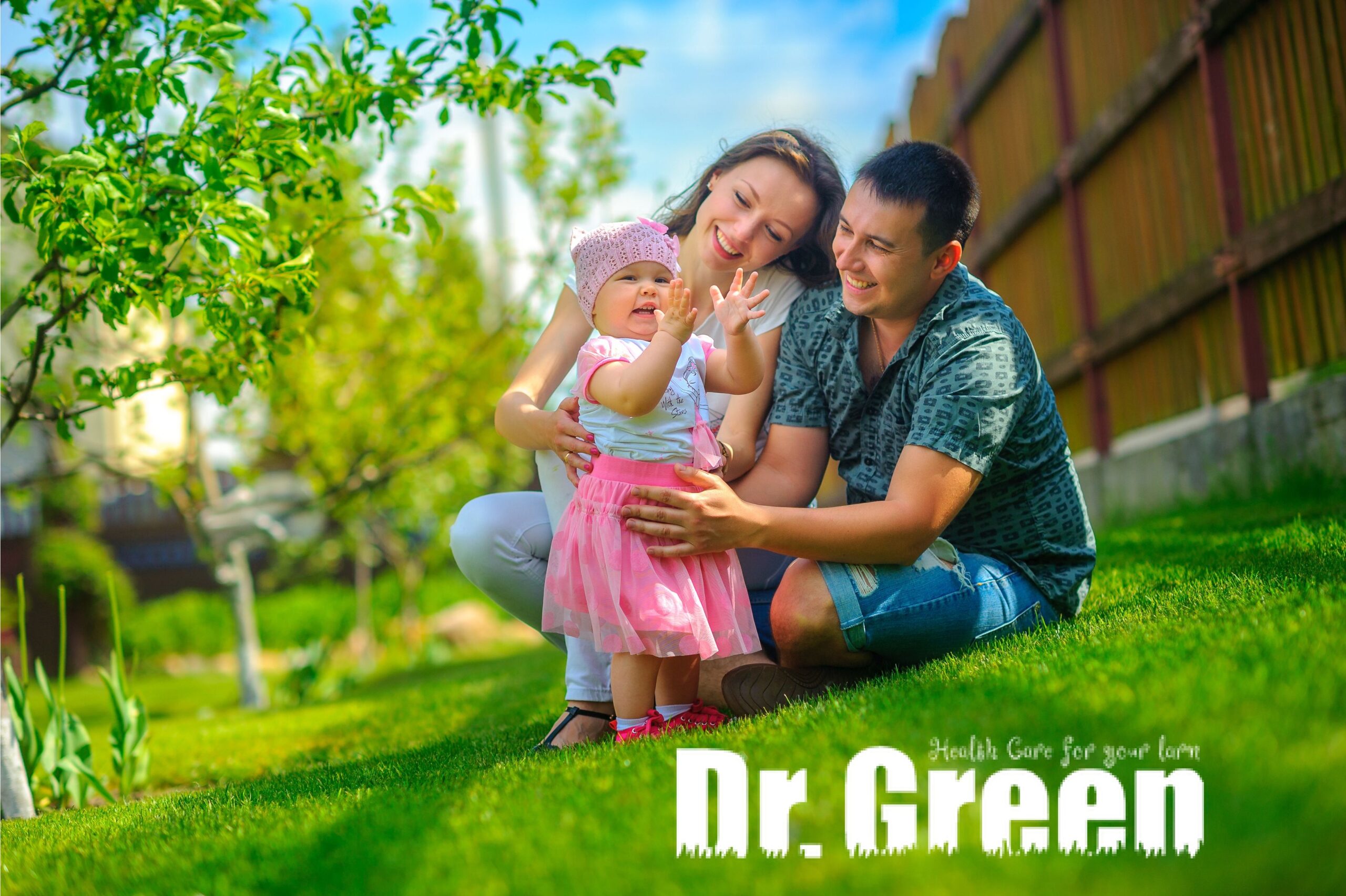 Family sitting on lush green grass