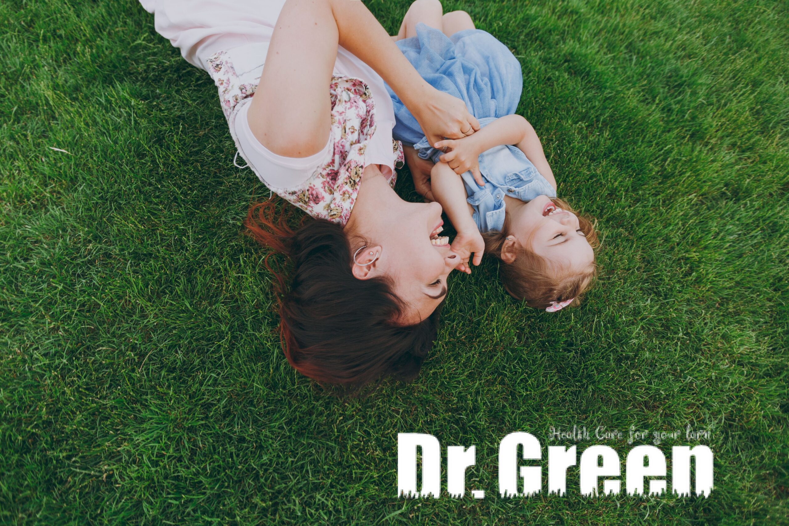 Mother and daughter enjoying a perfect lawn free from grub damage