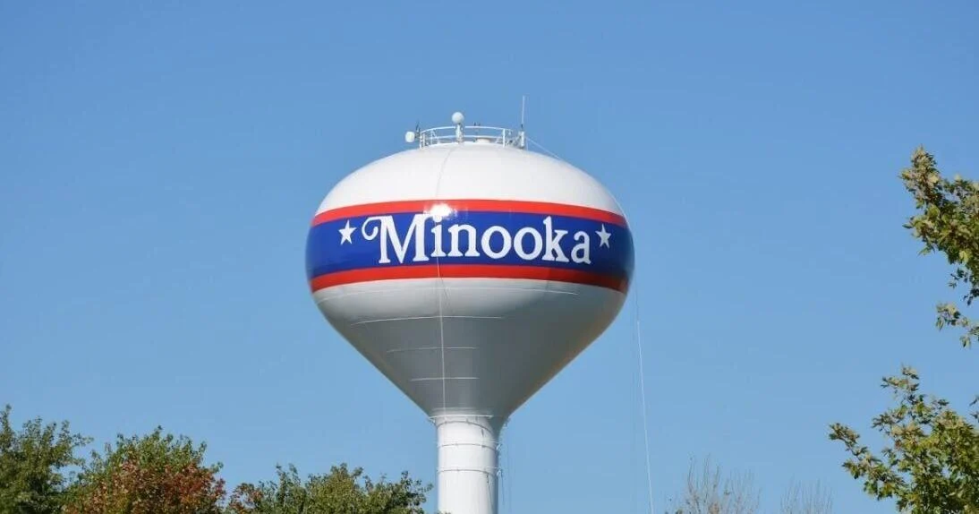 Well-known Minooka water tower with lush green surroundings.