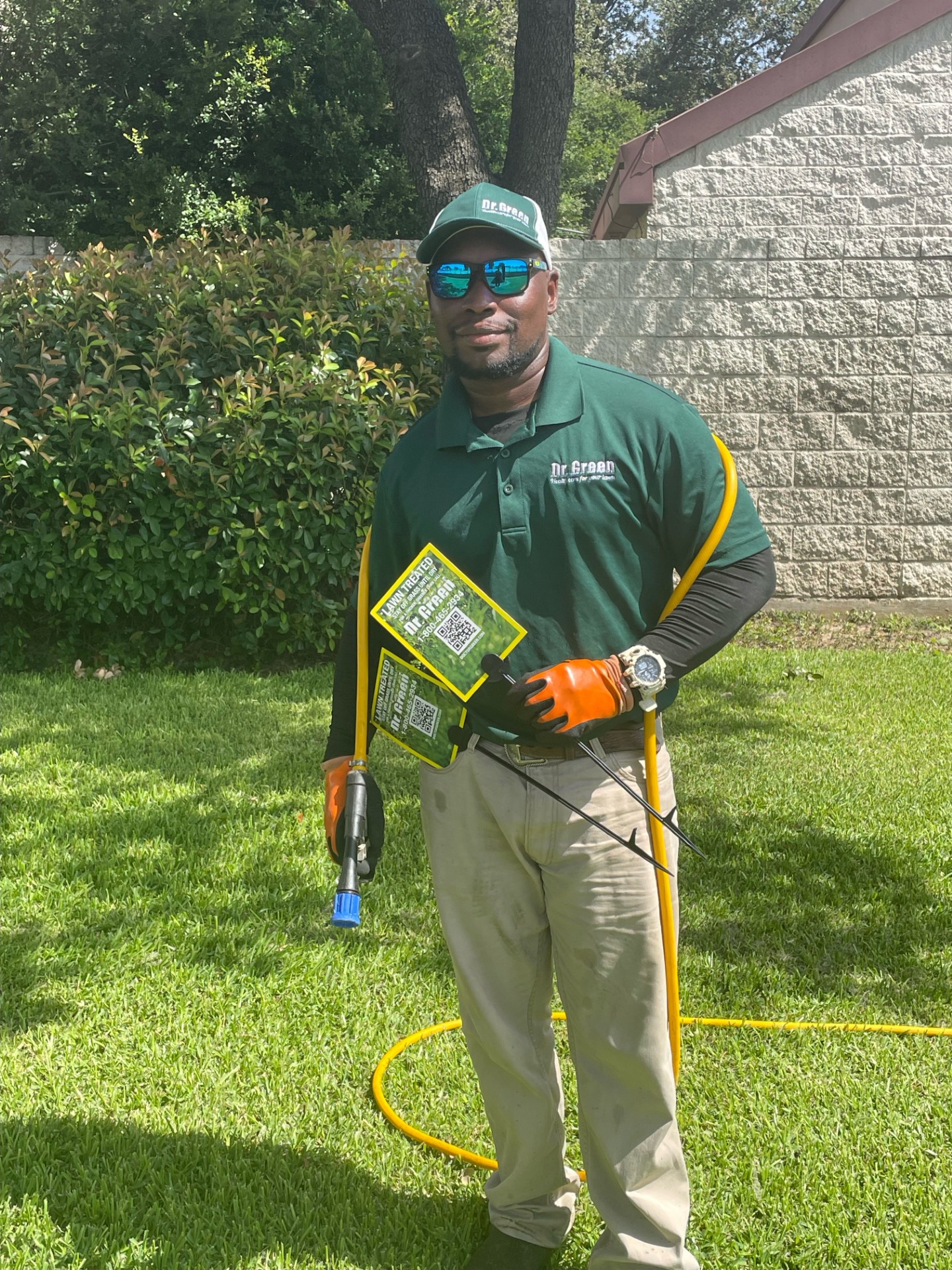 A certified technician from Coppell Lawn Care applying lawn care treatments while ensuring effective mosquito control in a lush, green yard in Coppell, Texas.