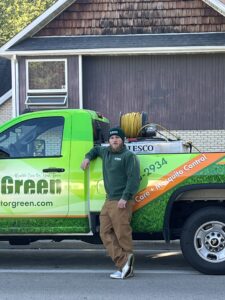 Operations Manager Marc Harris stands proudly in front of our truck, dedicated to delivering the best Chicagoland lawn care.