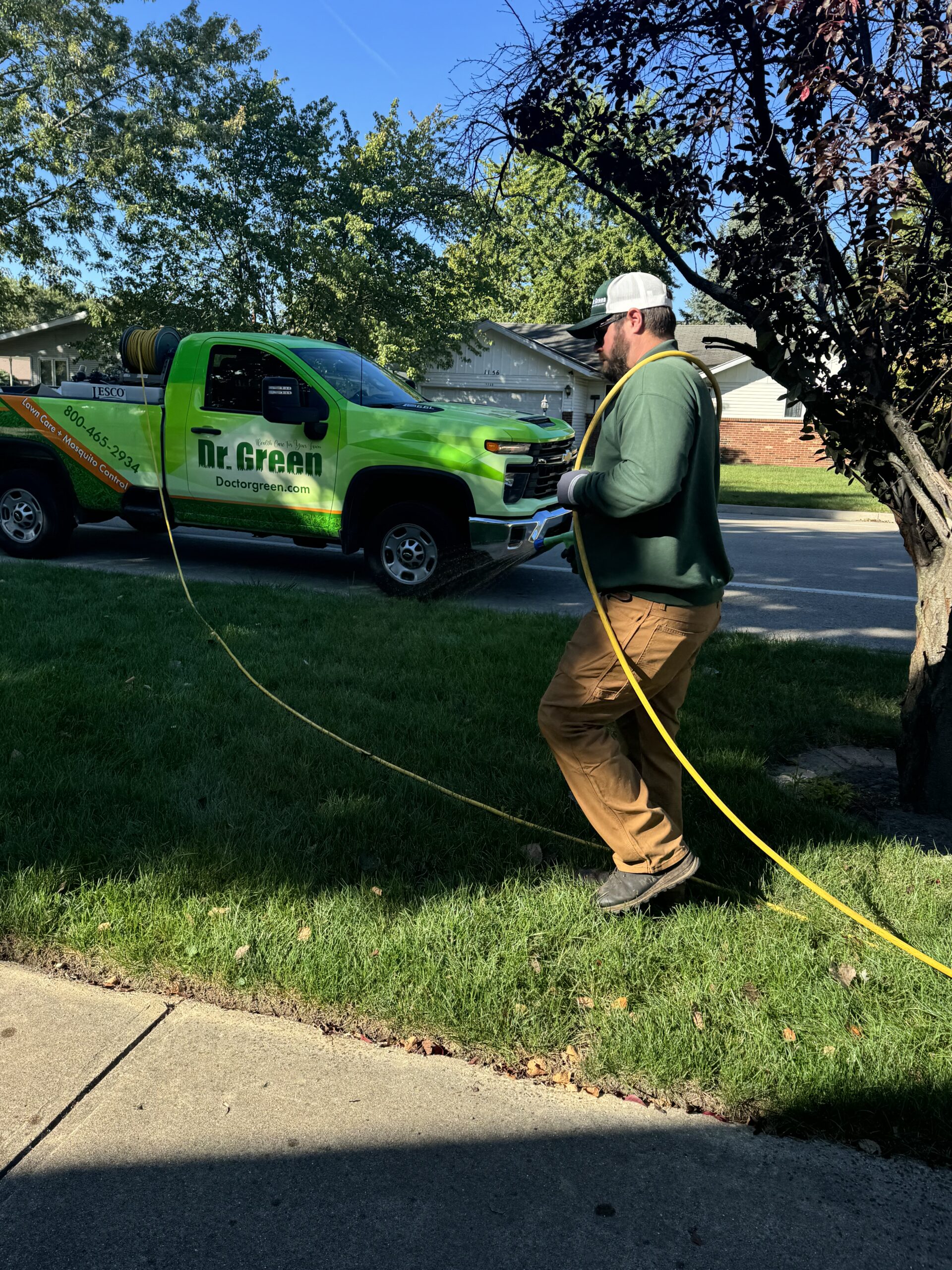Tyler, a certified technician for Dr. Green Services, providing lawn care in Plainfield.