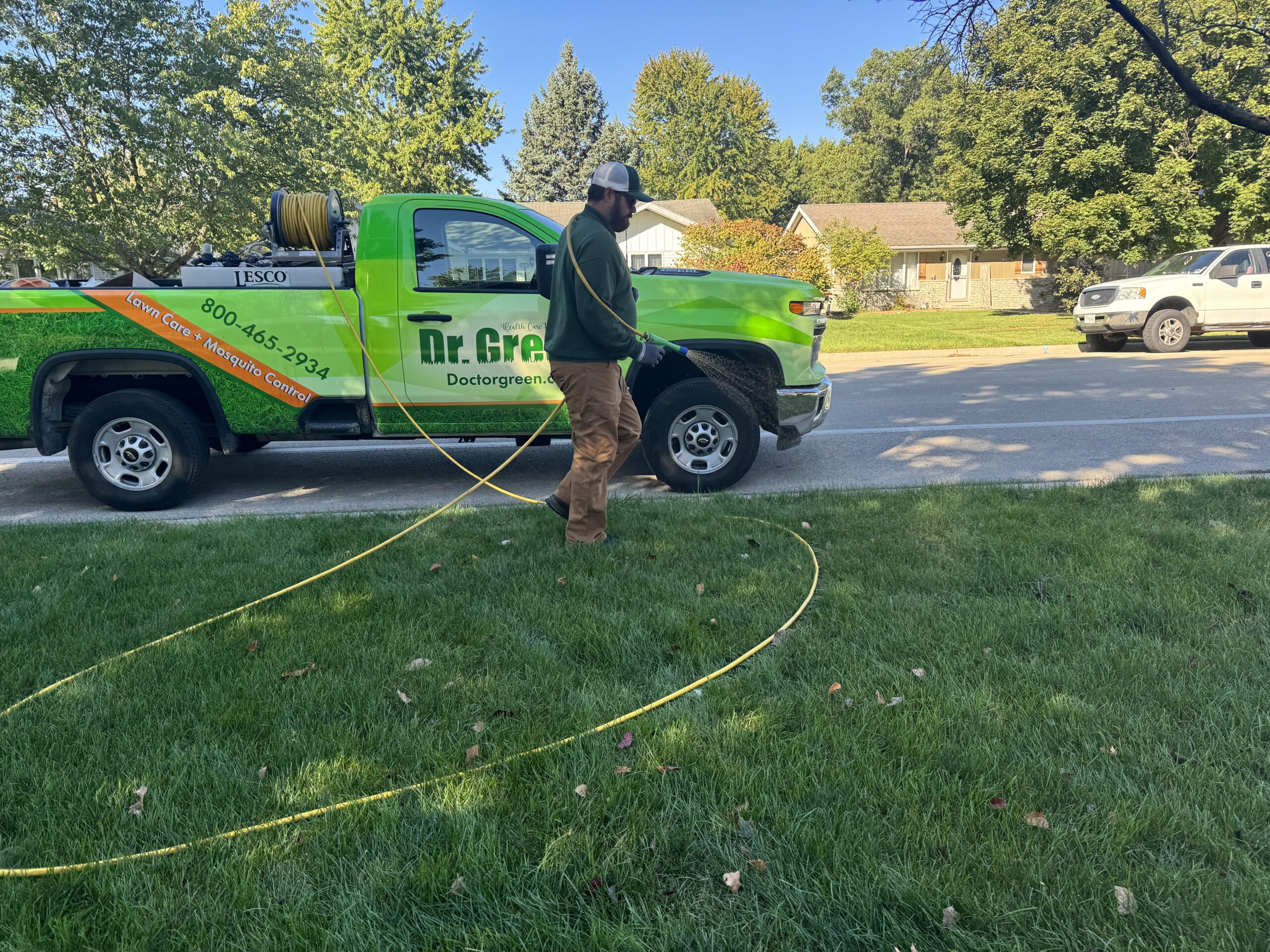 Certified technician showcasing a green and weed-free lawn for Homer Glen Lawn Care.