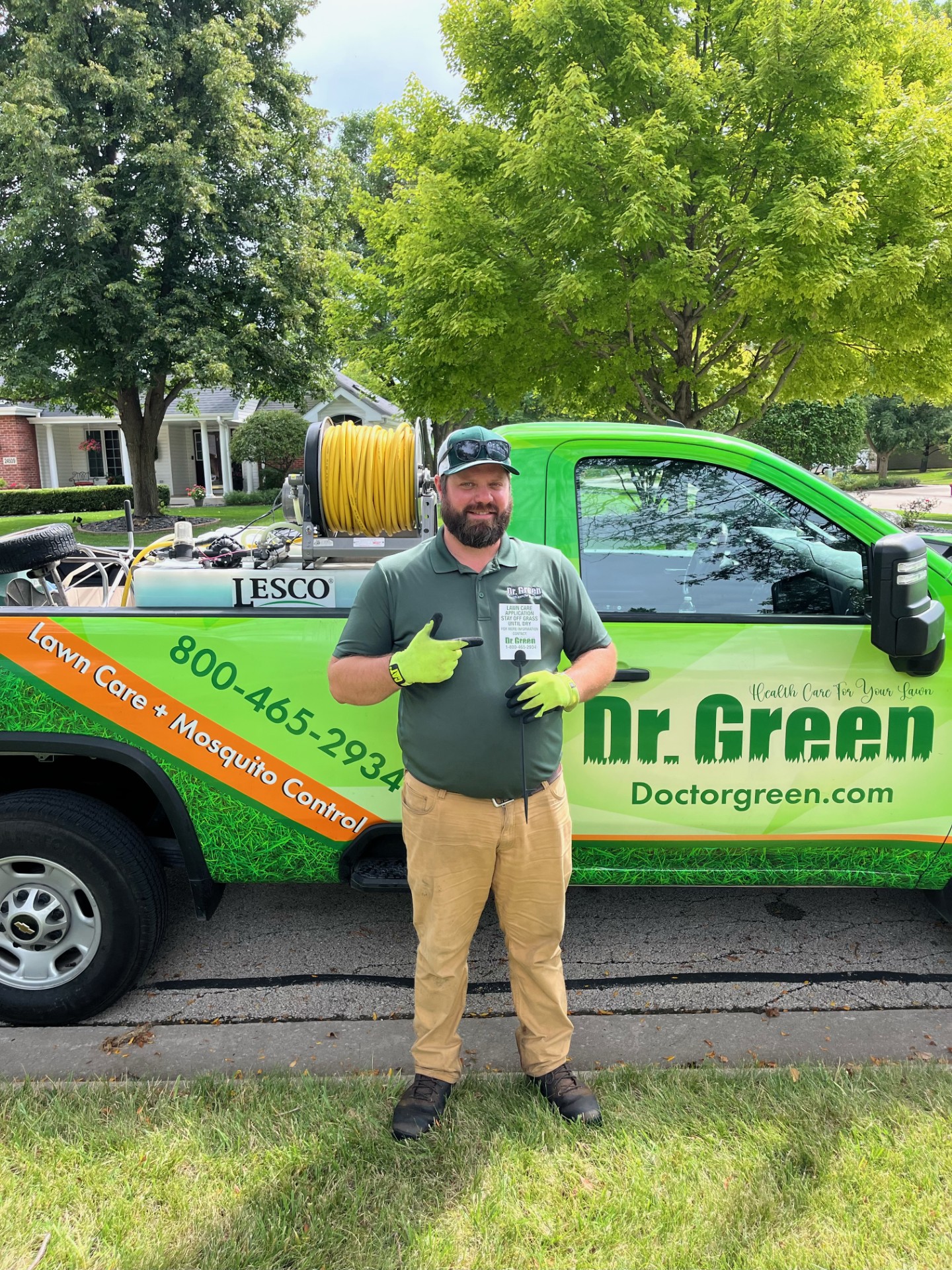 Dr. Green Services certified technician providing expert Schererville Lawn Care for a green and weed-free lawn.