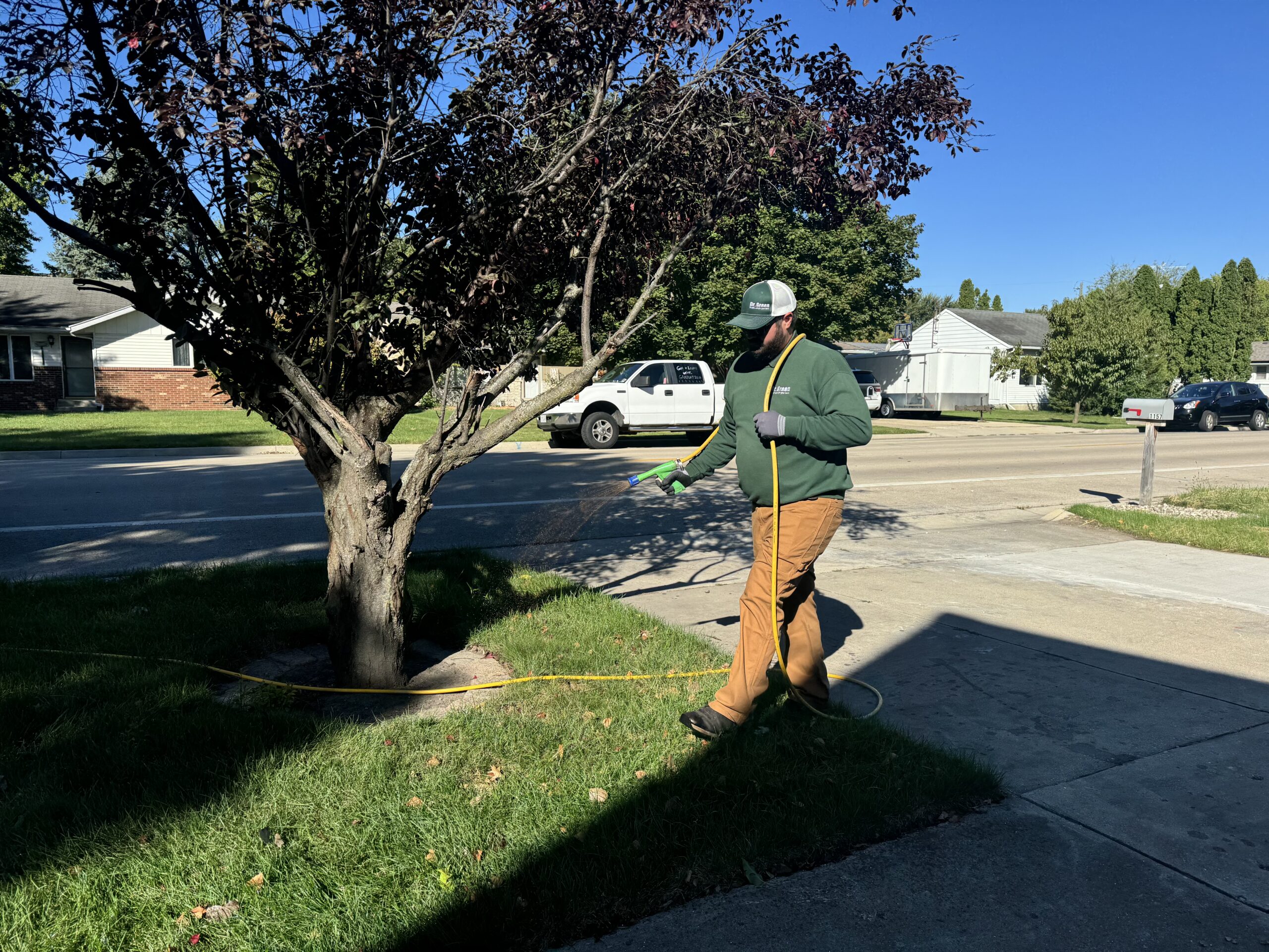 Certified technician from Dr. Green Services providing Tinley Park Lawn Care, creating a green and weed-free lawn.