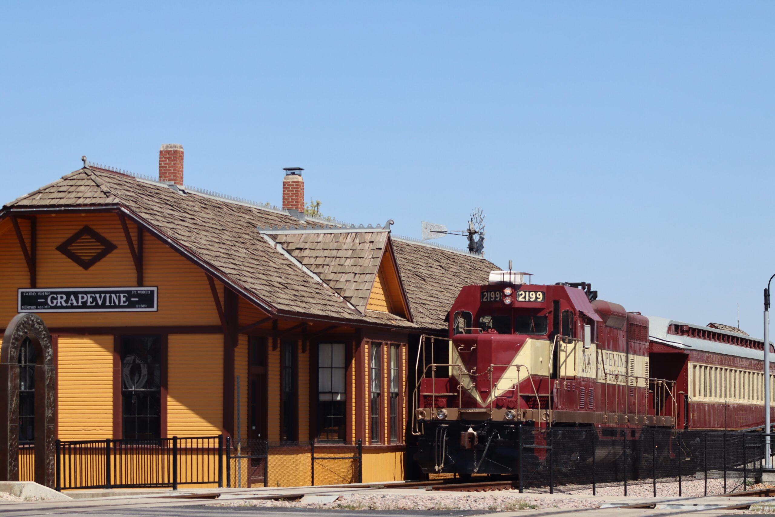Historic downtown Grapevine Train Station surrounded by vibrant scenery.