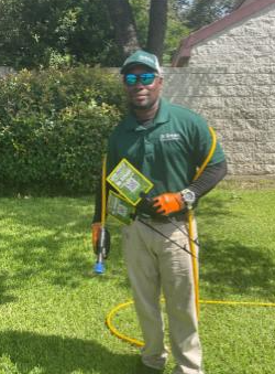 Certified technician from Dr. Green Services providing expert care for a green and weed-free lawn in Highland Village.