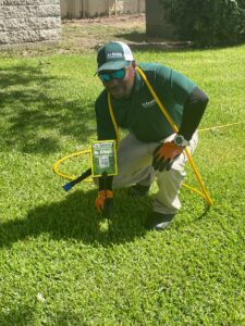 Dr. Green Services technician diligently working to prevent fire ants from invading a lawn.