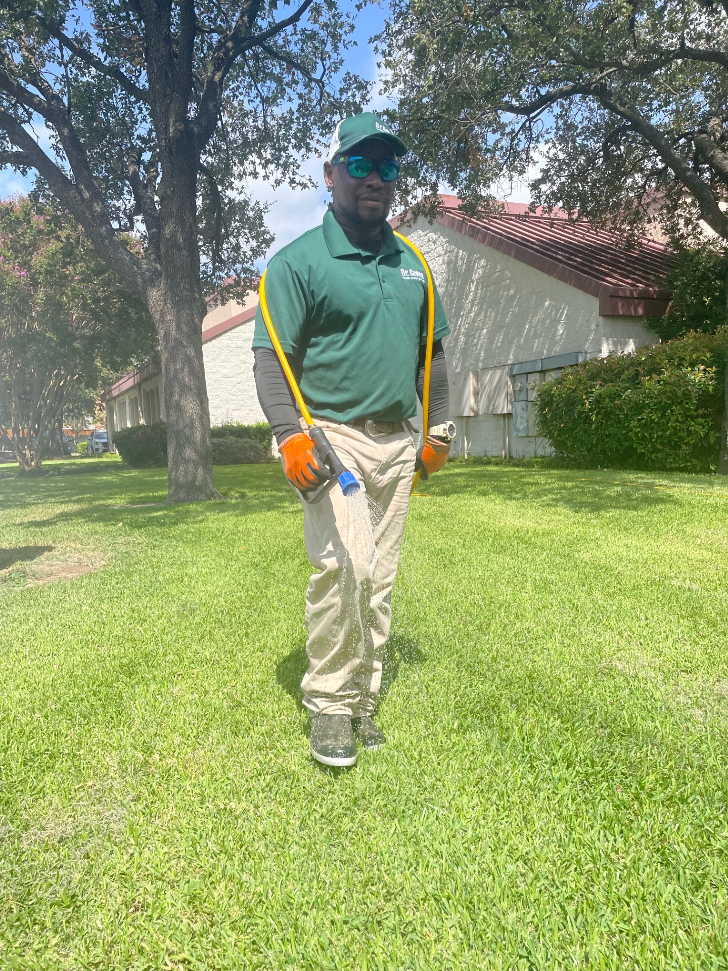 Certified technician from Dr. Green Services ensuring a green and weed-free lawn in Mansfield, Texas.