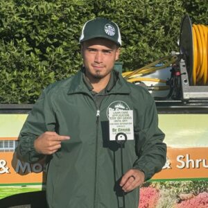 Dr. Green Services technician applying liquid aeration on a residential lawn