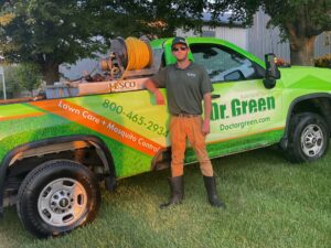Dr. Green Services technician applying fall lawn care treatment