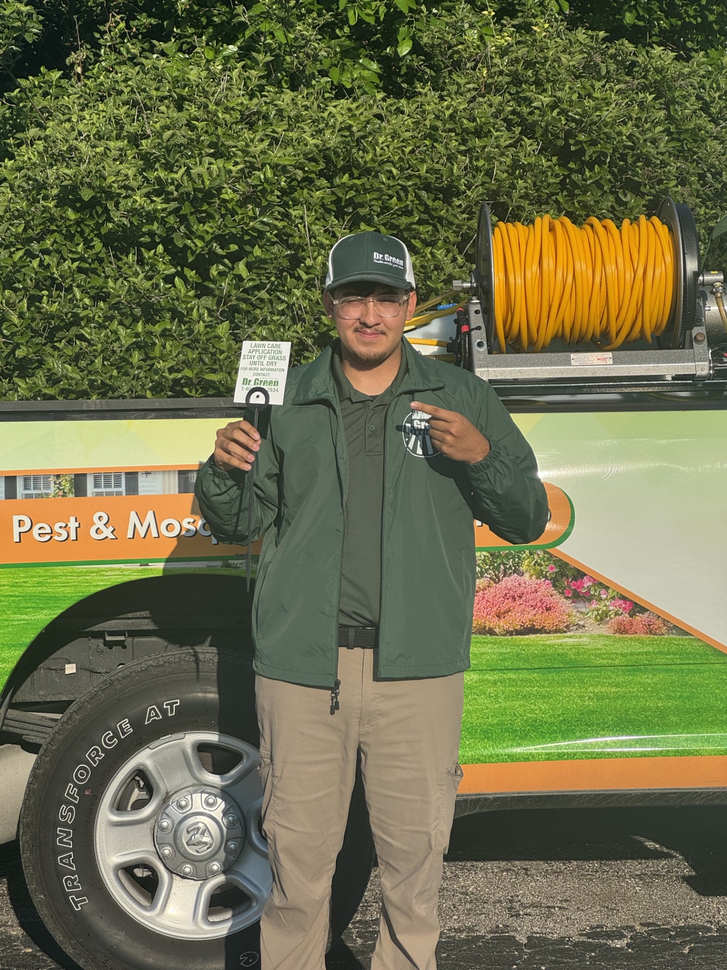 Dr. Green Services technician applying professional lawn care treatment in West Chicago.